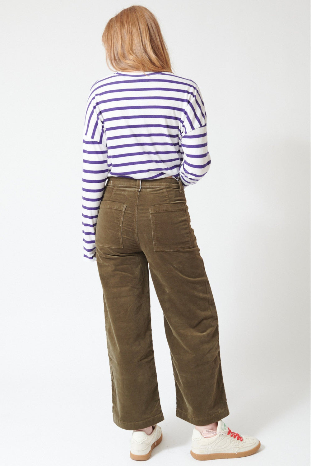 Waverly wearing ASKK NY Virginia Corduroy Pant in Safari Green, rear view.