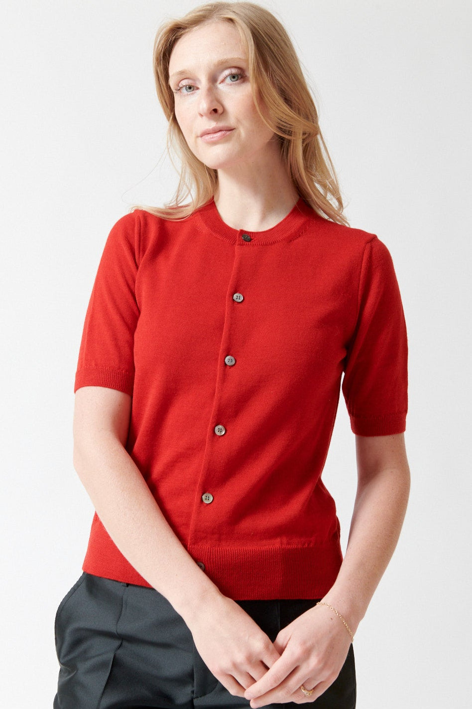Madi wearing Comme des Garçons Short Sleeve Wool Crew Cardigan front view