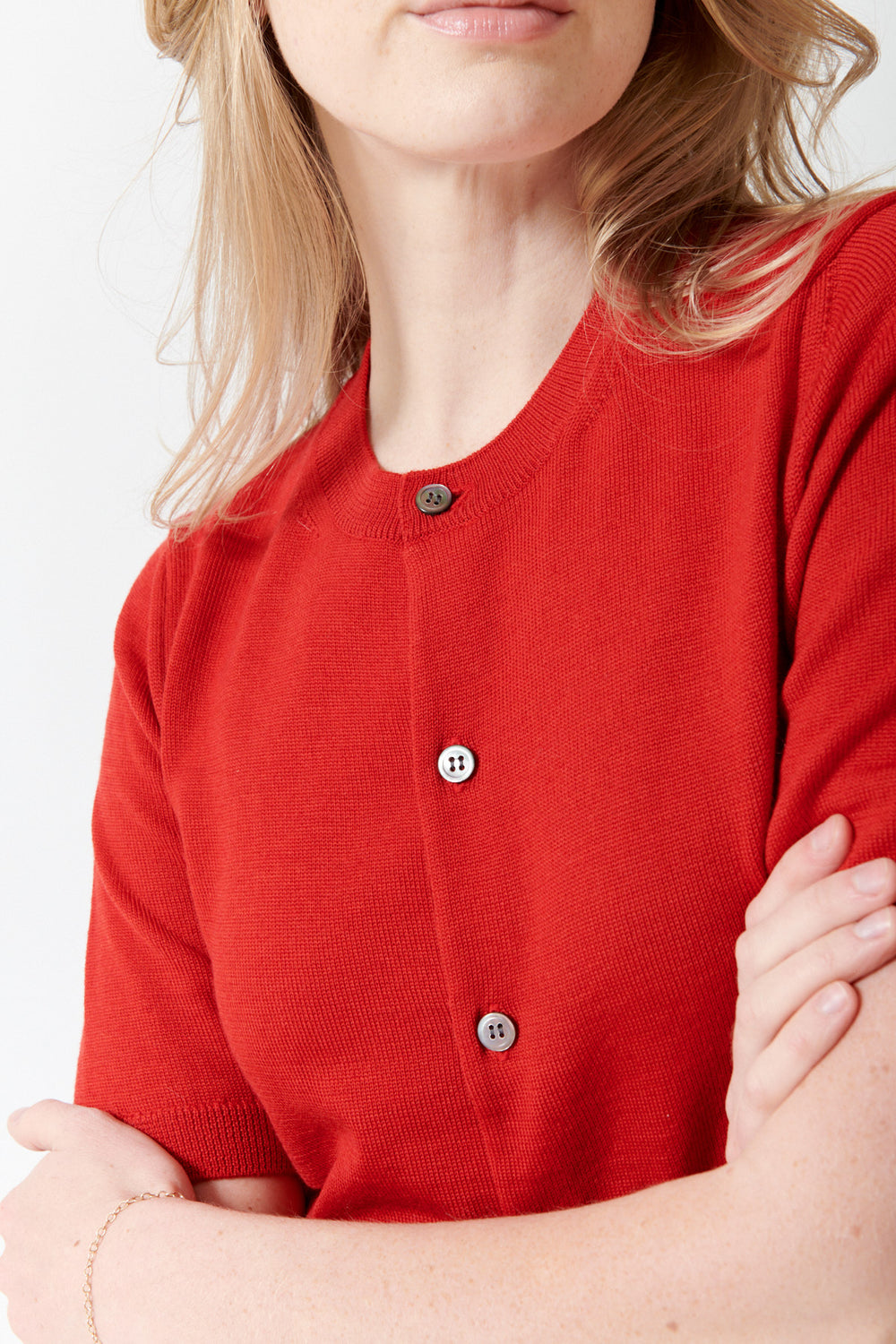 Madi wearing Comme des Garçons Short Sleeve Wool Crew Cardigan front/detail view
