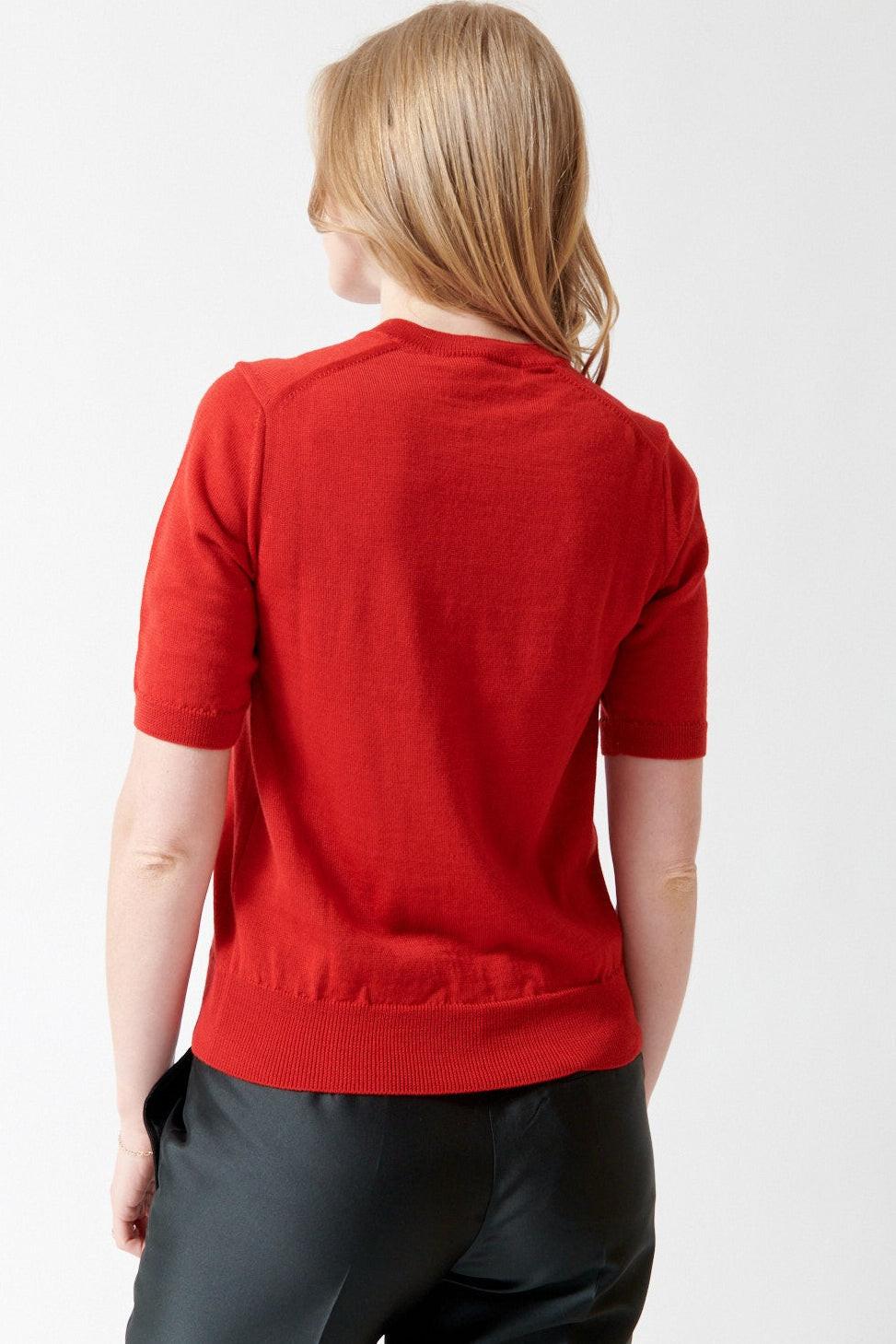 Madi wearing Comme des Garçons Short Sleeve Wool Crew Cardigan rear view