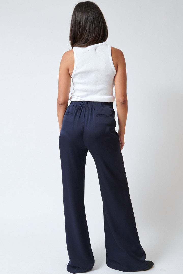 Amanda wearing Allude Touch On Silk Elastane Trousers Deep Night rear view
