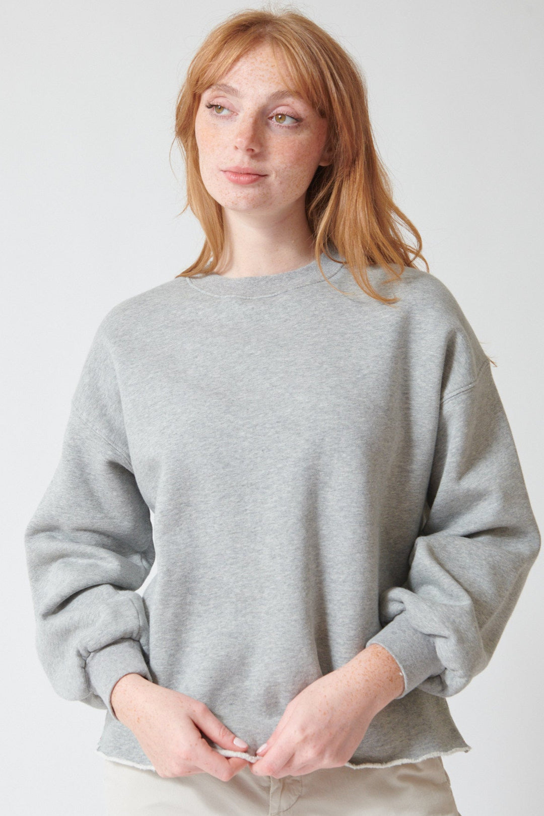 Waverly wearing Xirena Honor Sweatshirt in Heather Grey, front view.