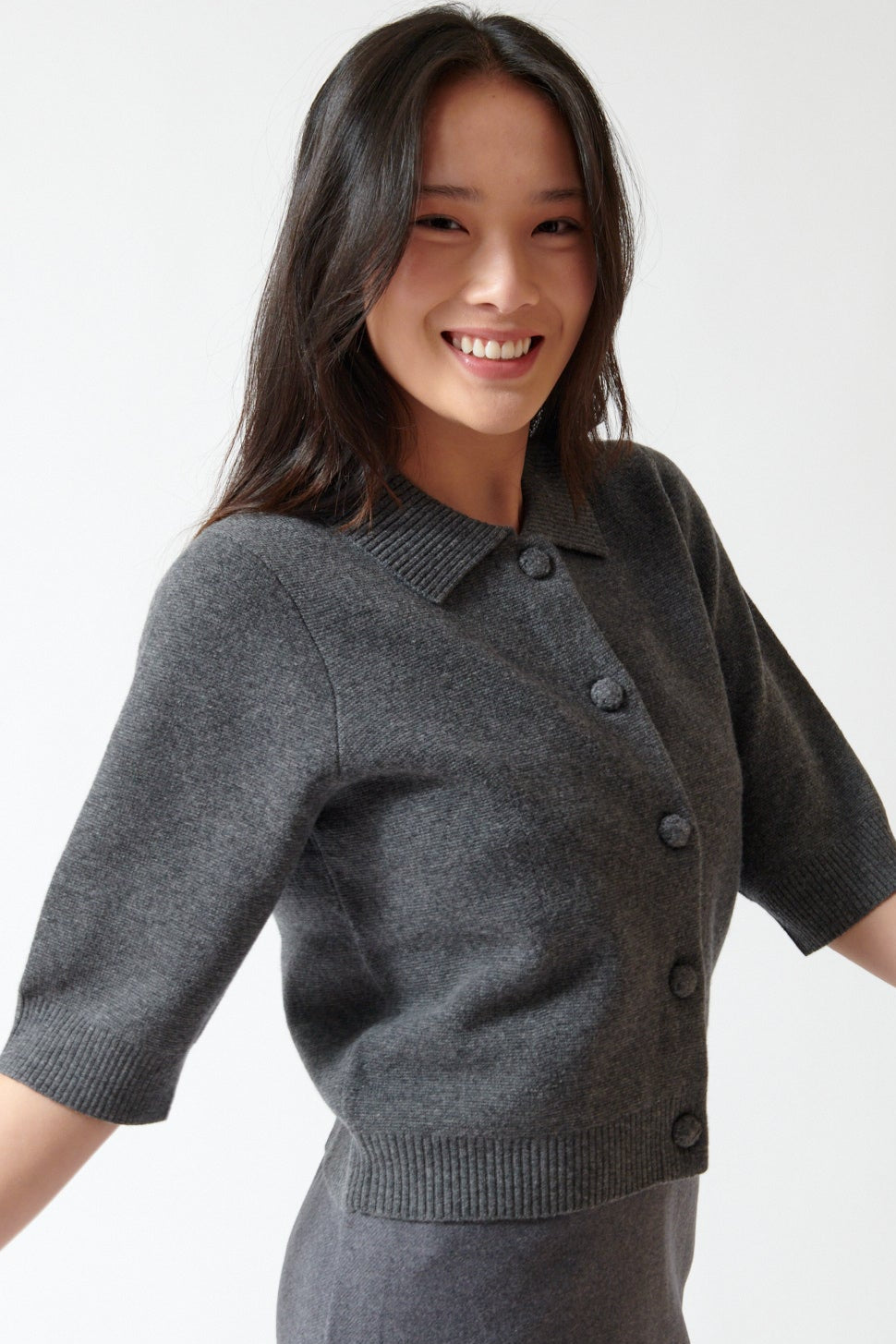 Lilly wearing The Garment Como Short Cardigan front/side view