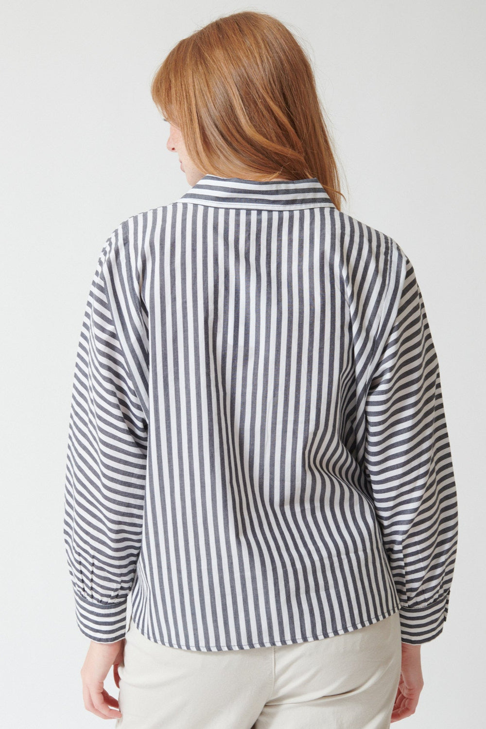 Waverly wearing Lilla P Dolman Sleeve Button Down Shirt in Navy White Stripe, rear view.