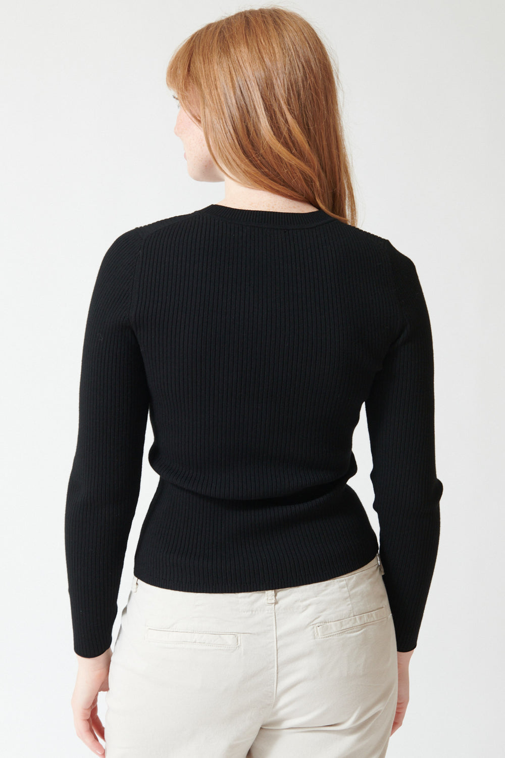 Waverly wearing Lilla P Fitted Crewneck Sweater in Black, rear view.