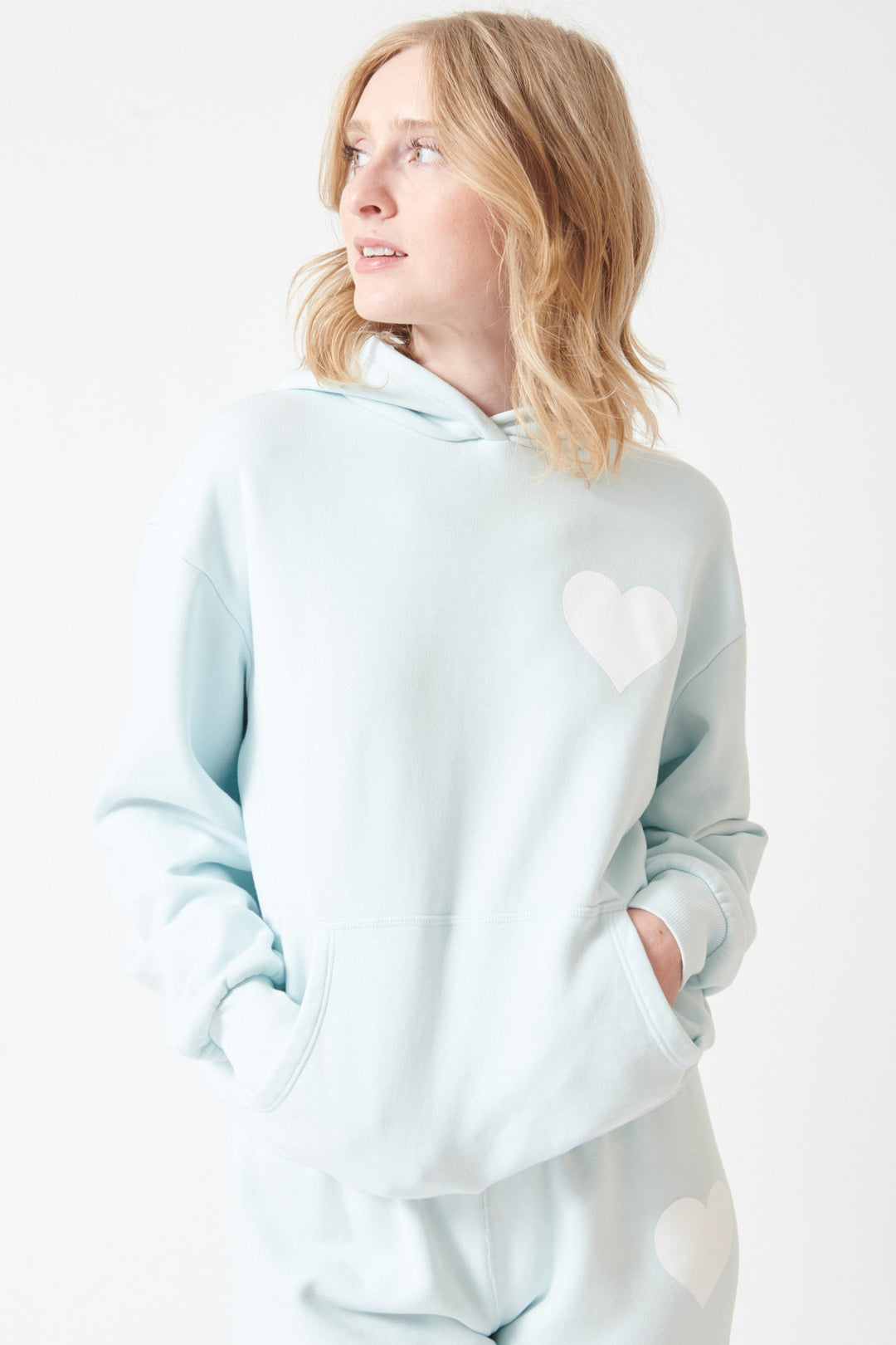 Madi wearing SPRWMN Heart Hoodie front view