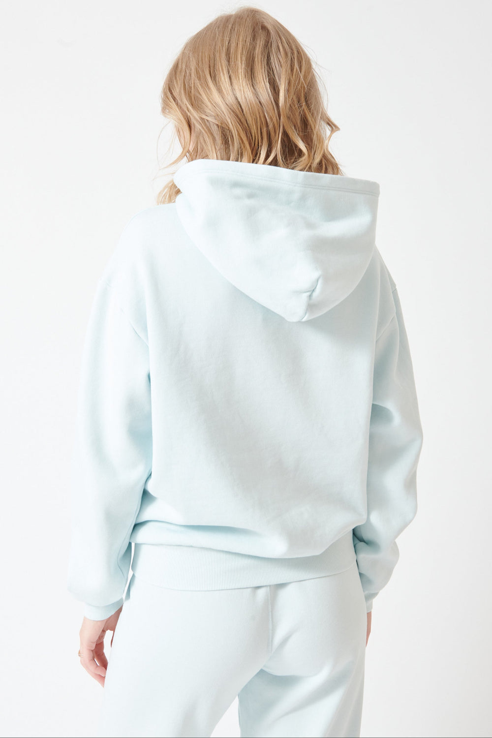 Madi wearing SPRWMN Heart Hoodie rear view