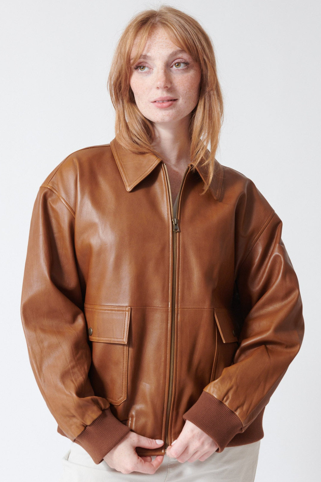 Waverly wearing The Great The Flight Jacket in Saddle Brown, front view.