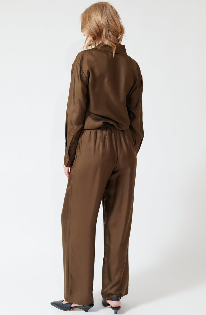 Madi wearing Róhe Wide Leg Silk Trousers rear view