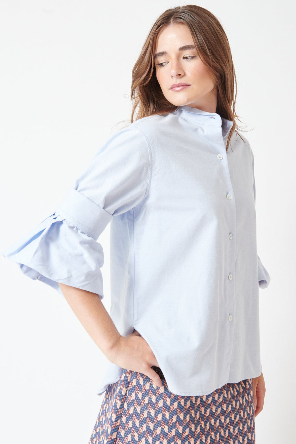 Julia wearing Odeeh Washed Oxford All About The Sleeves Shirt front/side view