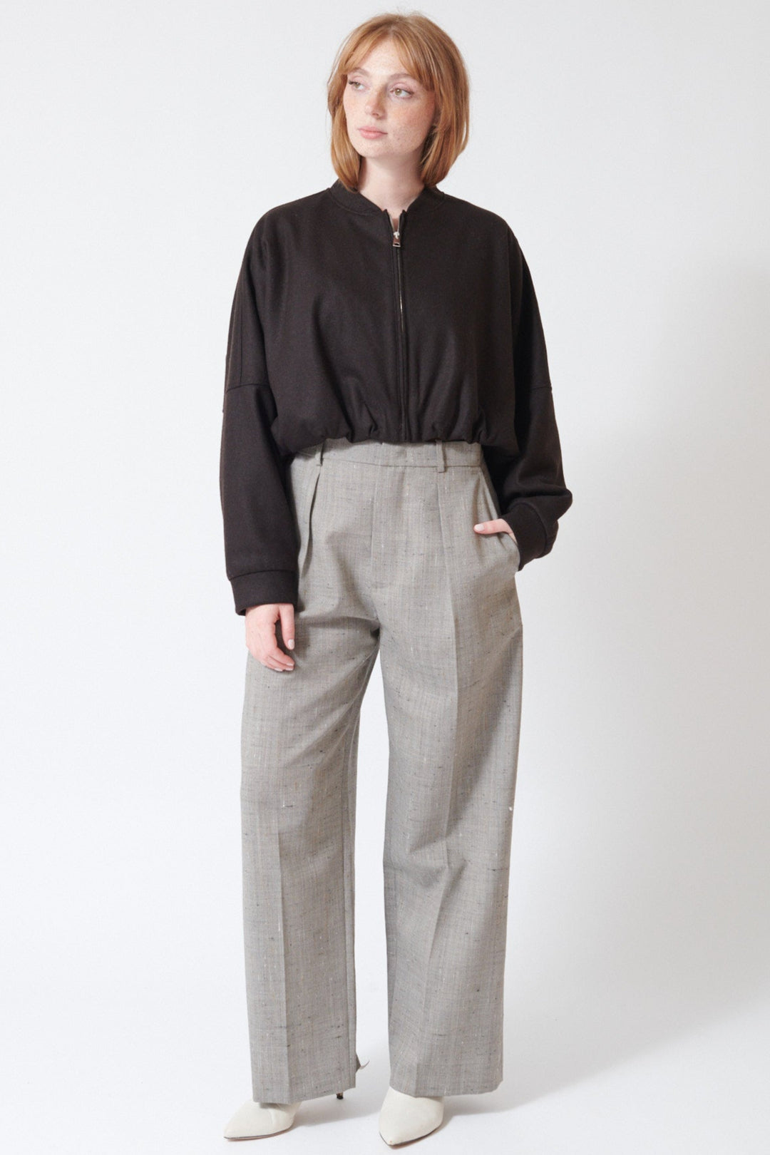 Waverly wearing Tela Manchester FLM Trousers in Grey Sand, front view.