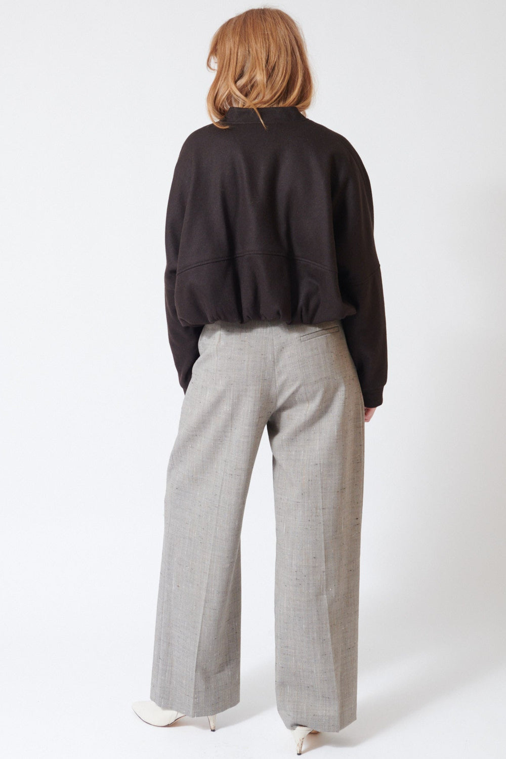 Waverly wearing Tela Manchester FLM Trousers in Grey Sand, front view.