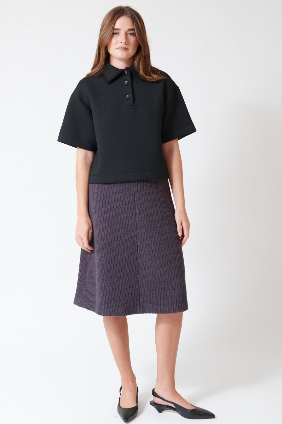 Julia wearing Tela Sadie Skirt in Dark Grey, front view.