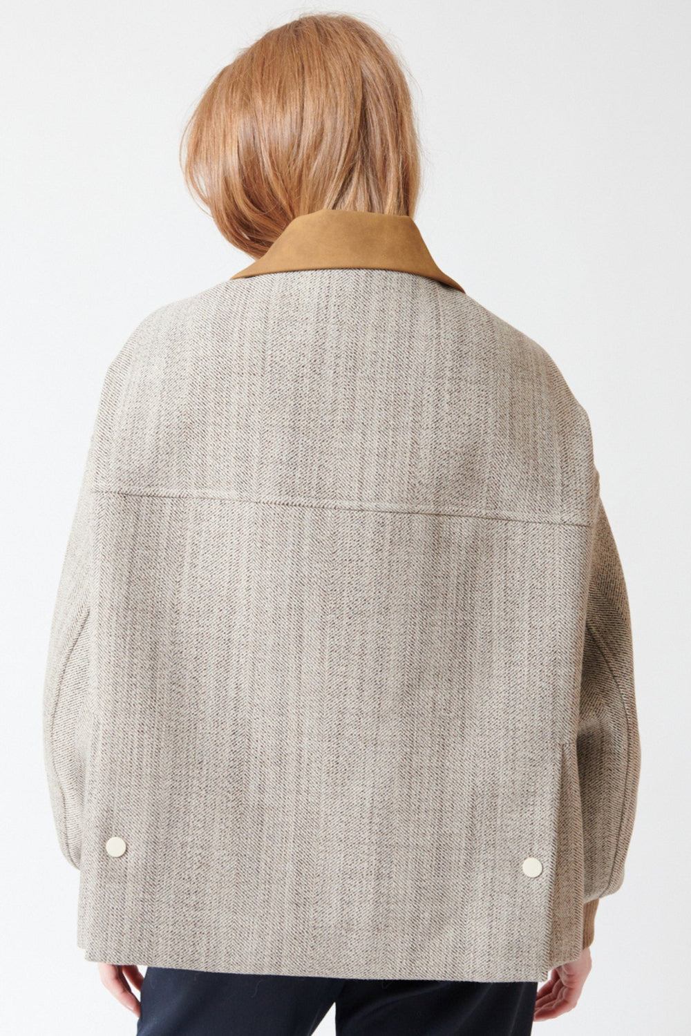 Waverly wearing Tela Bubble Spin in Natural, rear view.