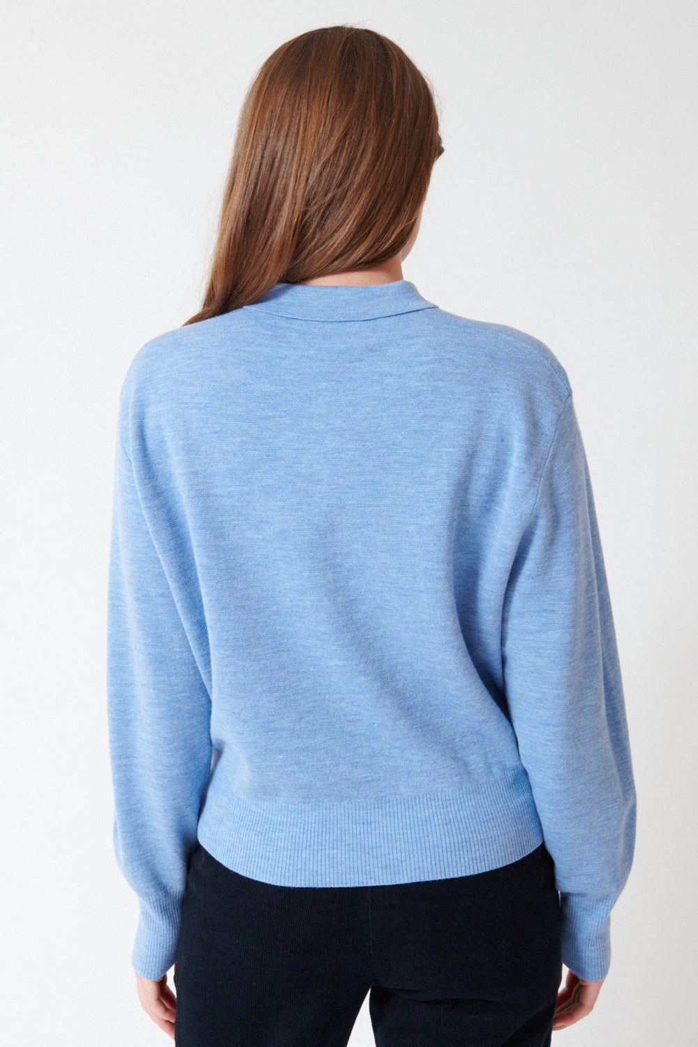 Julia wearing Apiece Apart Kari Polo Knit in Heathered Sky, rear view.