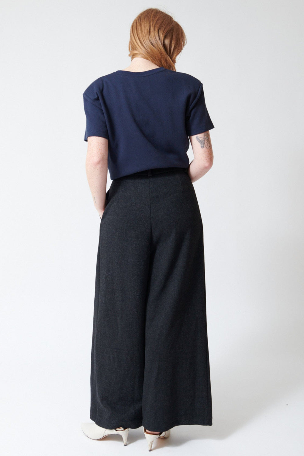 Waverly wearing ELEH Modern Muldoon Trouser in Charcoal, rear view.
