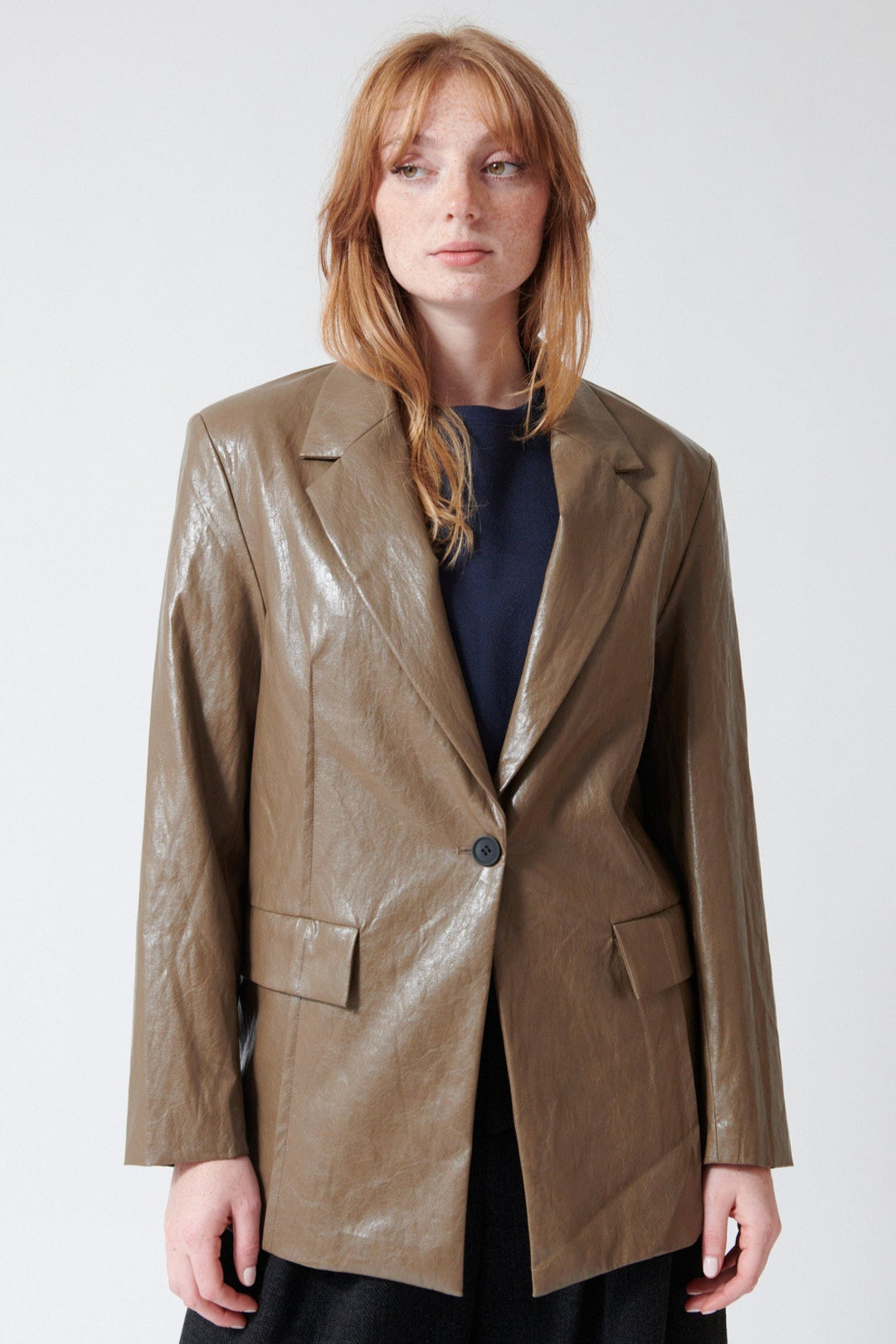Waverly wearing ELEH Polly Esther Leather Look Blazer in Taupe, front view.