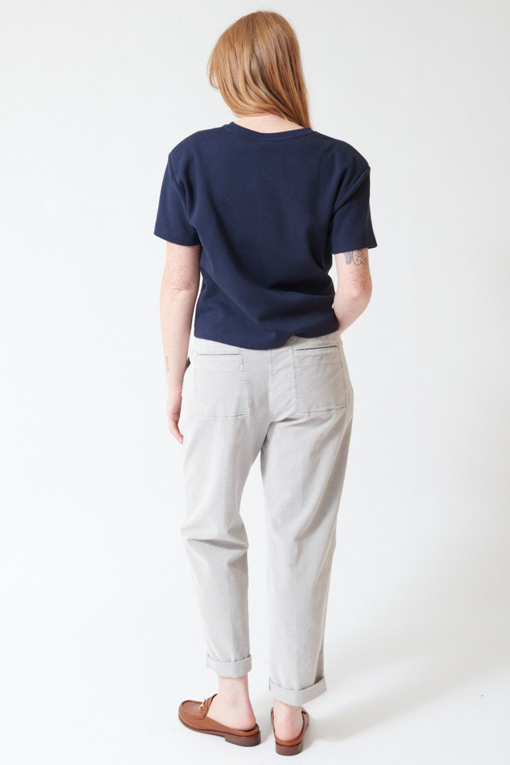 Waverly wearing Peserico Stretch Cotton Ready To Dye Corduroy Pants in Stone Grey, rear view.