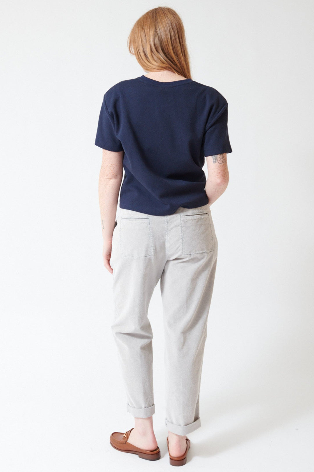 Waverly wearing Peserico Stretch Cotton Ready To Dye Corduroy Pants in Stone Grey, rear view.