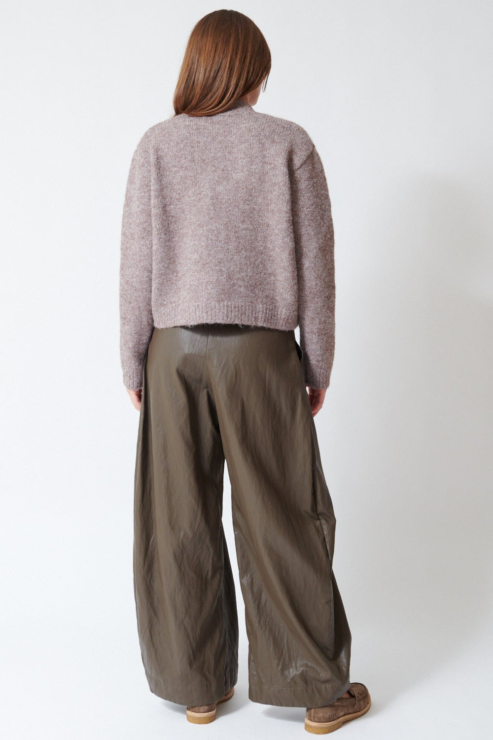 Julia wearing ELEH Wide Leg Leather Look Trouser in Dark Taupe, rear view.