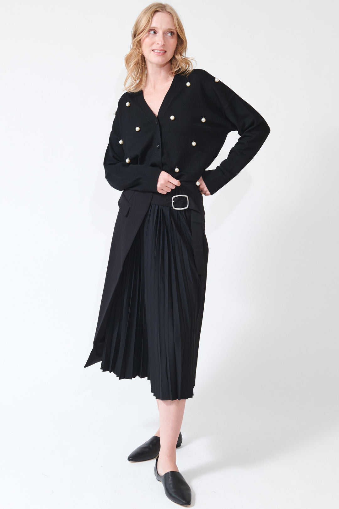 Madi wearing Buckled Flat And Pleated Wrap Skirt Black front view