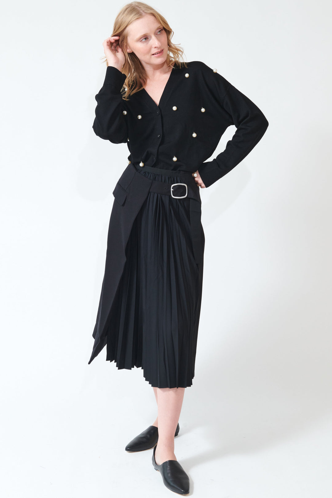 Madi wearing Buckled Flat And Pleated Wrap Skirt Black front view