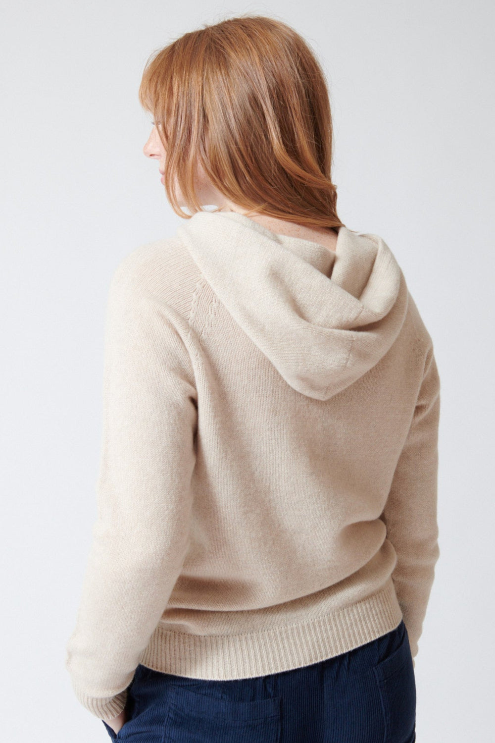 Waverly wearing Rosso 35 Wool Cashmere Hooded Pullover in Light Oat, front view.
