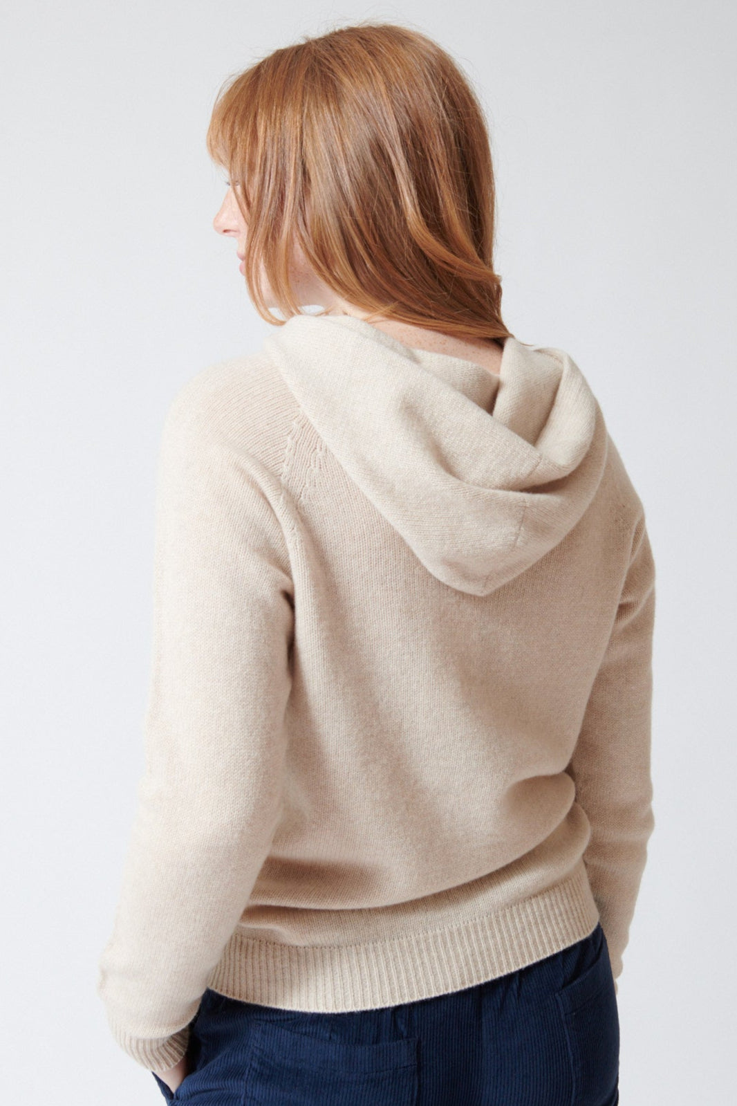 Waverly wearing Rosso 35 Wool Cashmere Hooded Pullover in Light Oat, front view.