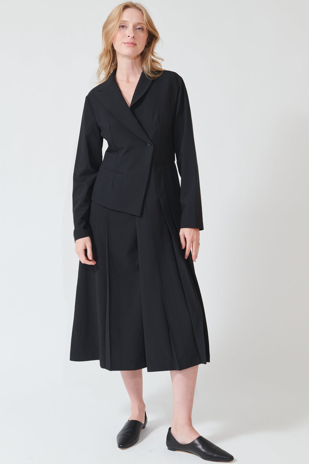 Maddie wearing Meimeij Half Blazer Pleat Dress front view