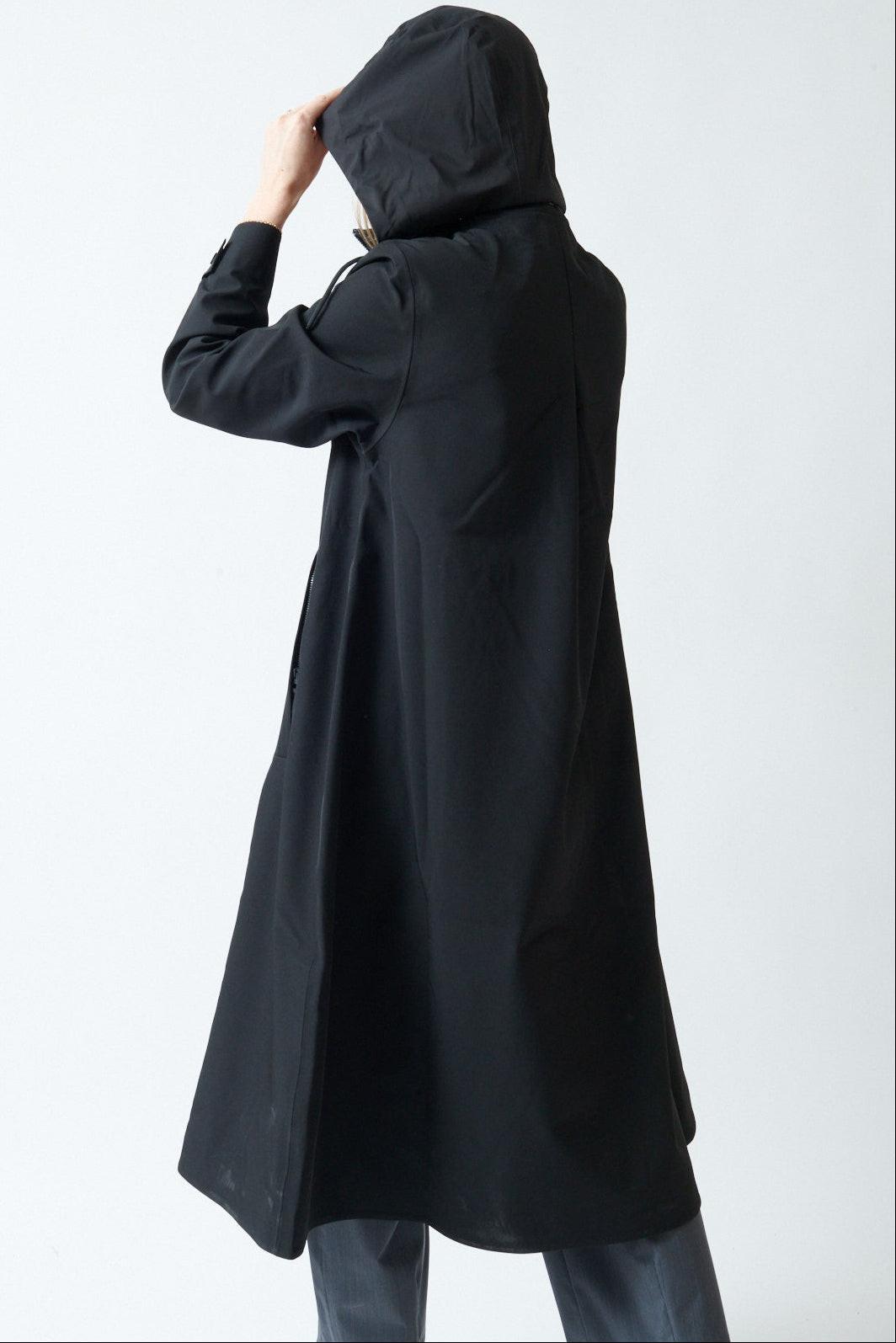 Madi wearing Rains Suva Vision Softshell A-Line W Jacket rear view