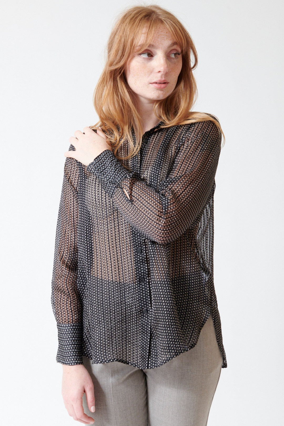 Waverly wearing Rosso 35 Sheer Silk Micro Print Blouse in Black, front view.