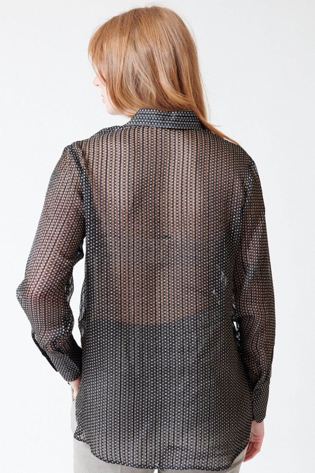 Waverly wearing Rosso 35 Sheer Silk Micro Print Blouse in Black, rear view.
