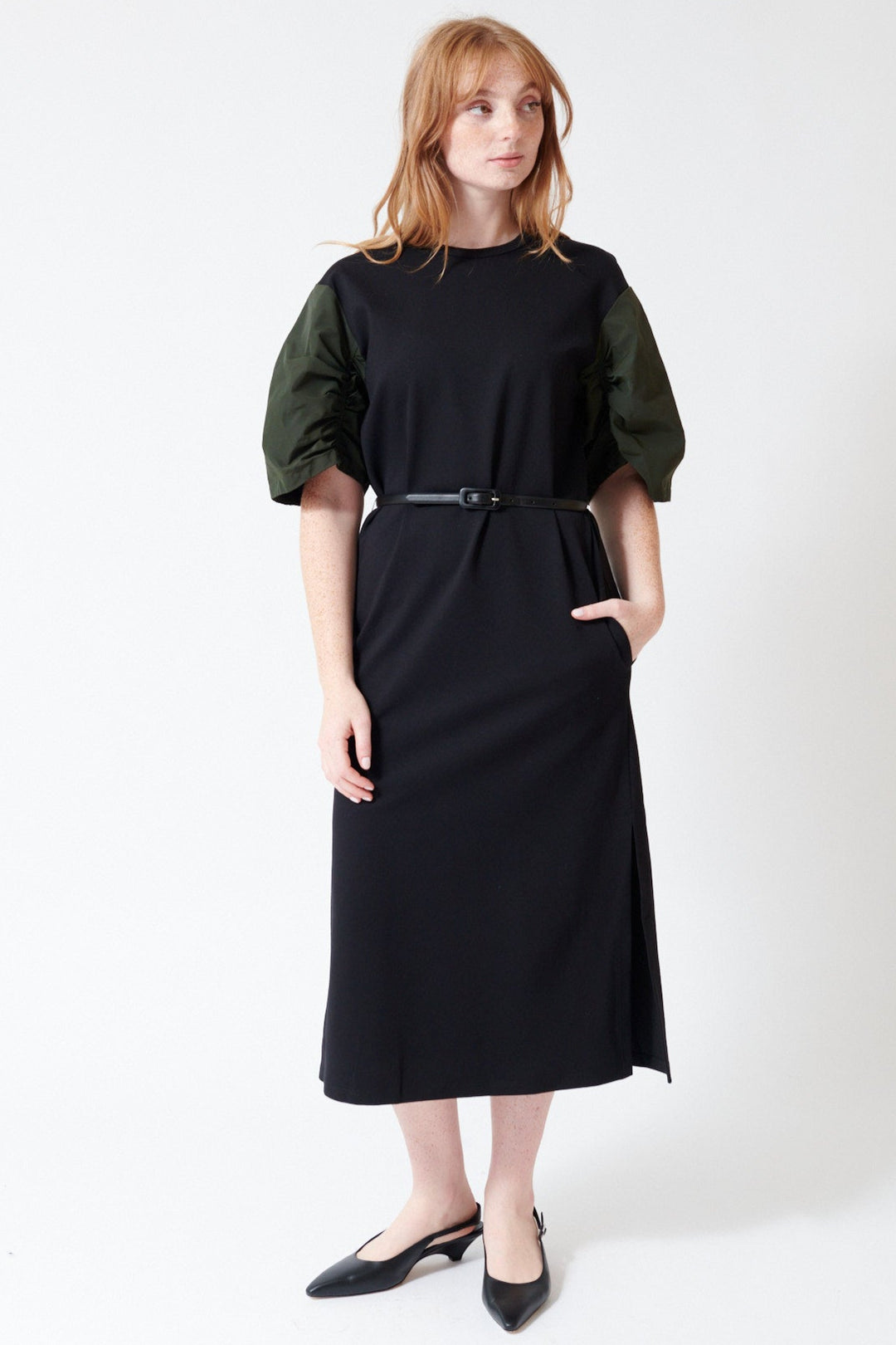Waverly wearing Mantu Faille Ruched Sleeve Dress in Black Green, front view.