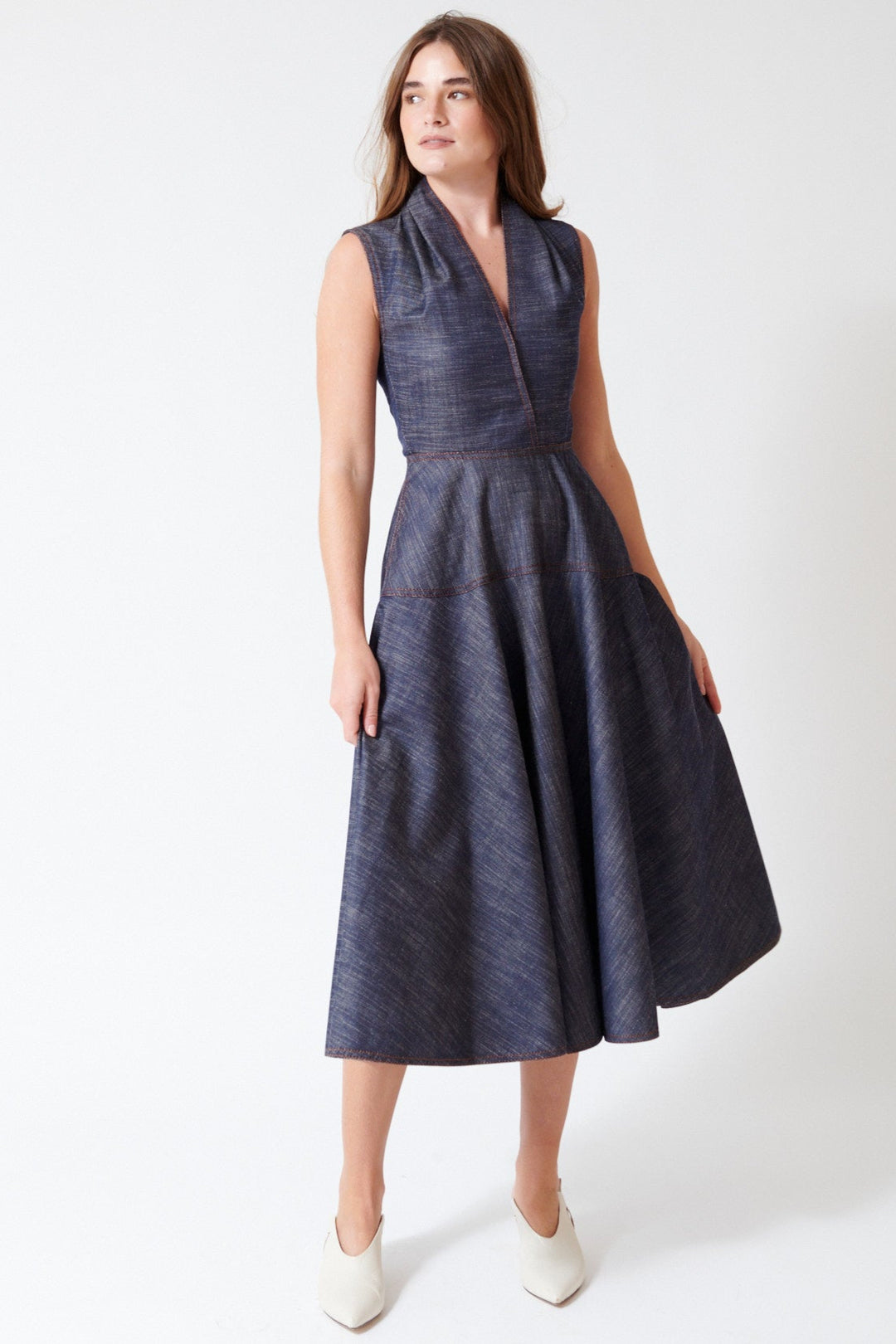Julia wearing Mantu Effetto Denim Sleeveless Dress in Night Blue, front view.