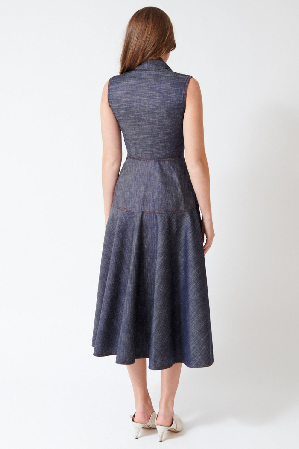 Julia wearing Mantu Effetto Denim Sleeveless Dress in Night Blue, rear view.