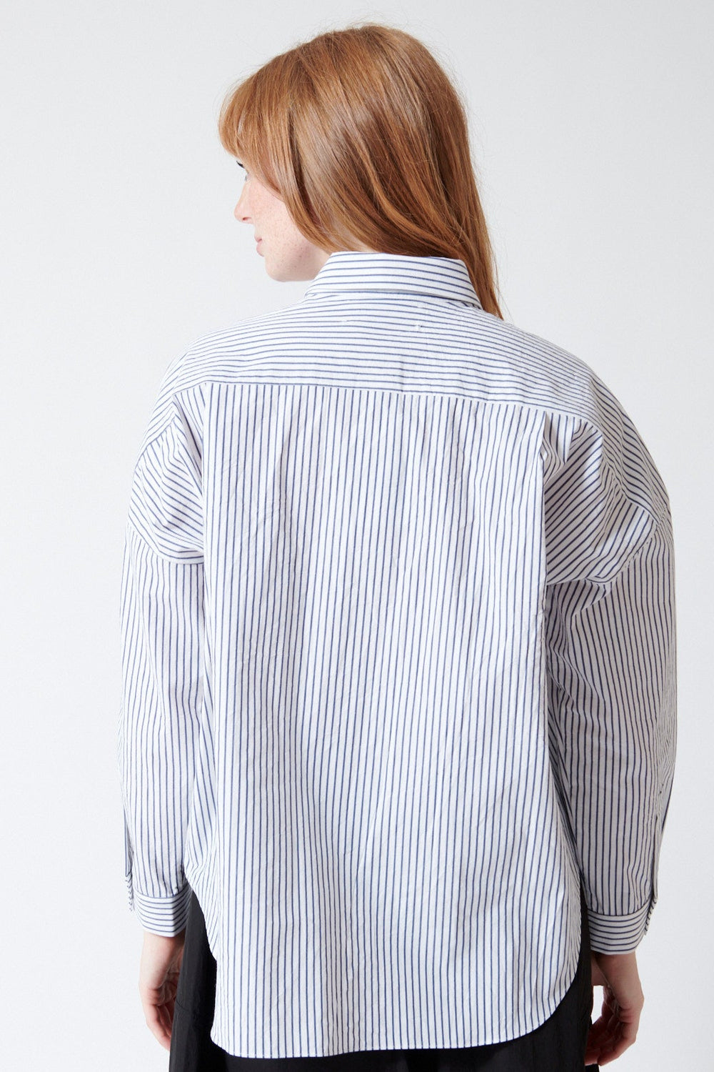 Waverly wearing Fabiana Pigna Egu Italian Stripe Cotton Blouse in Navy Stripe, rear view.