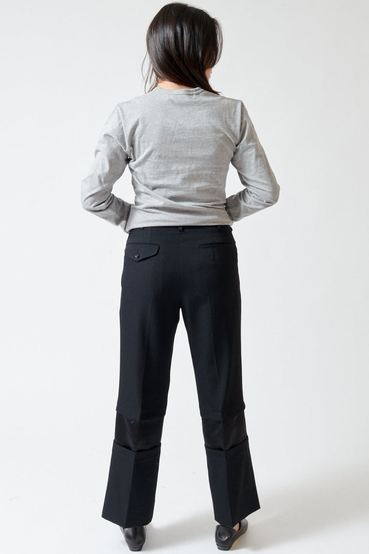 Lilly wearing Comme des Garçons Wool Gabardine x Poly Satin Banded Leg Trouser rear view