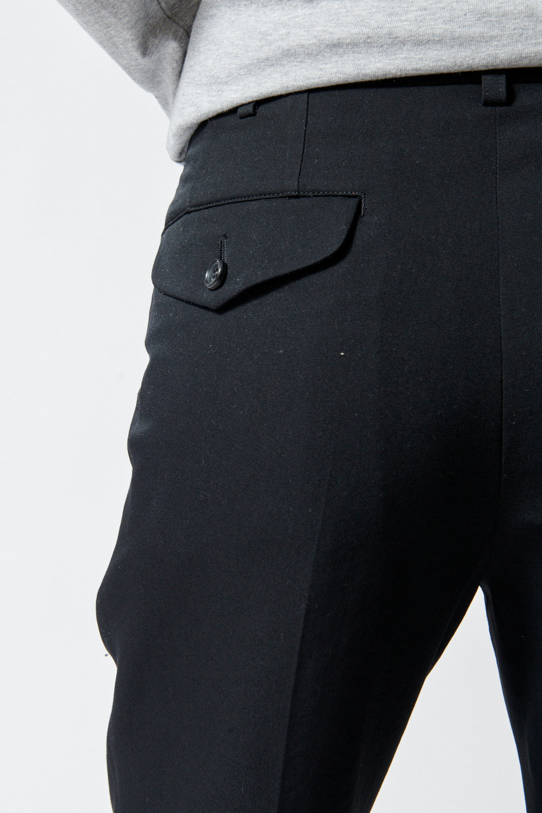 Lilly wearing Comme des Garçons Wool Gabardine x Poly Satin Banded Leg Trouser rear/pocket view