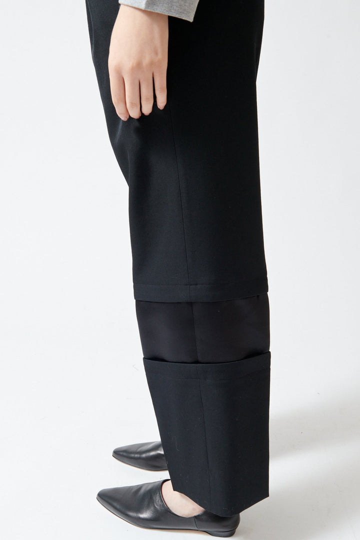 Lilly wearing Comme des Garçons Wool Gabardine x Poly Satin Banded Leg Trouser side/detail view