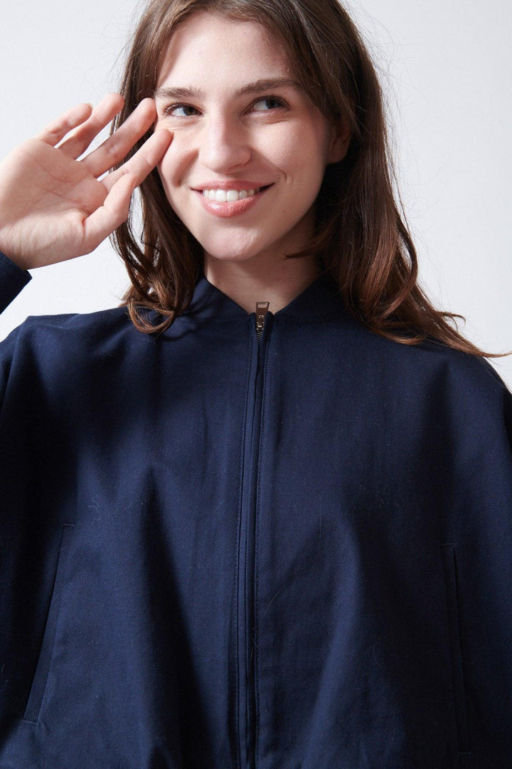 Sophie wearing Tela Ferdi Light Jacket front/detail view