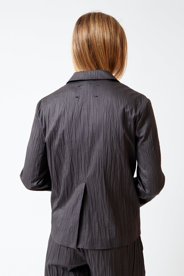 Mari wearing Tela Nomad Jacket Black rear view