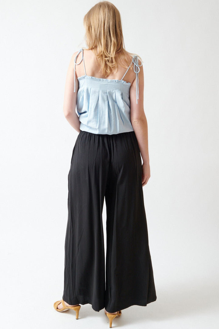 Madi wearing ELEH Beata Elastic Waist Trousers rear view