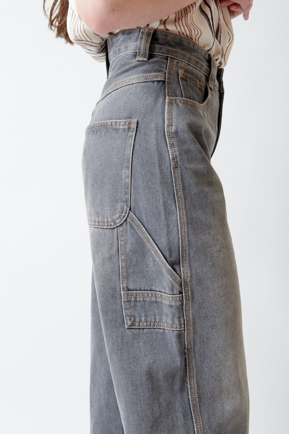 Angela wearing ELEH Ashen Denim Jeans side/detail view