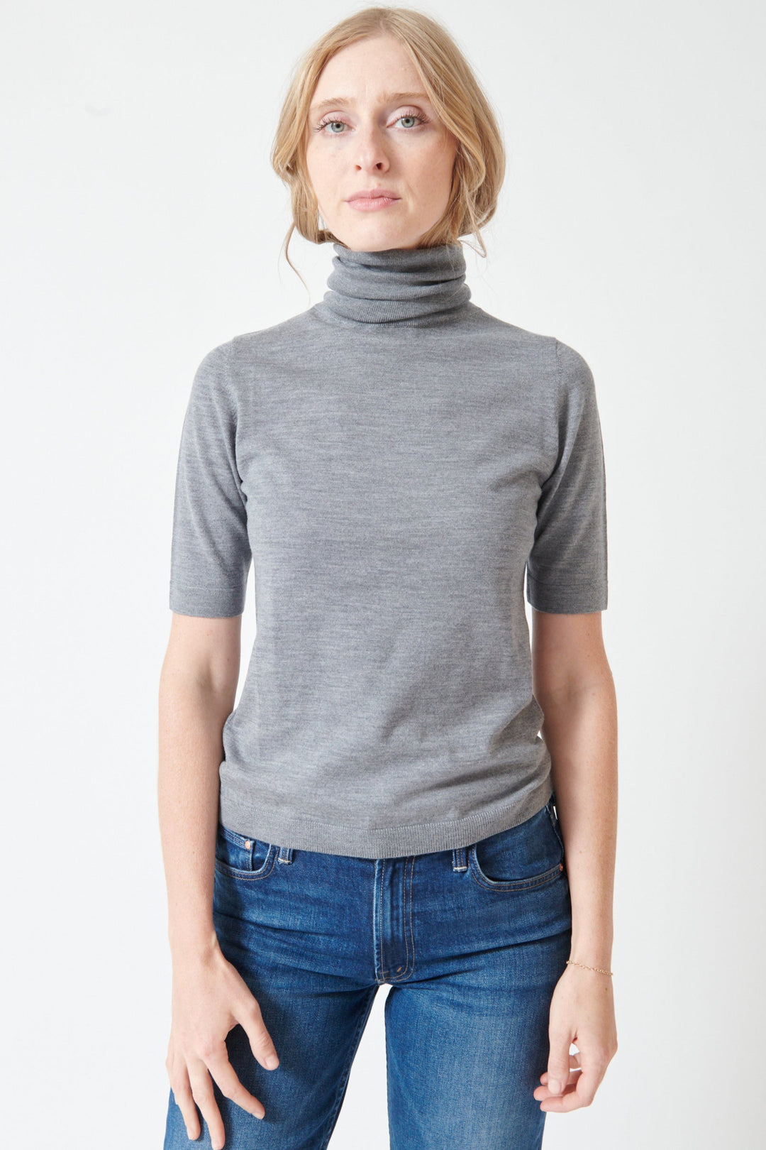 Madi wearing Allude Half Sleeve Fine Rib Wool Turtleneck Sweater front view