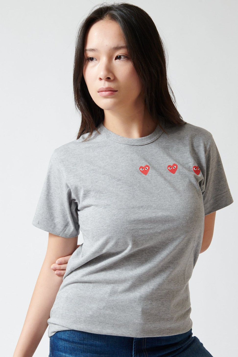 Lilly wearing Comme des Garçons PLAY Trio Heart Logo Print T-Shirt front view