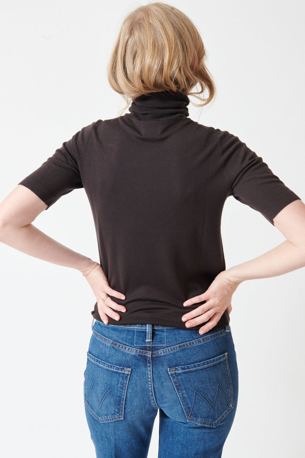 Madi wearing Allude Half Sleeve Fine Rib Wool Turtleneck Sweater rear view