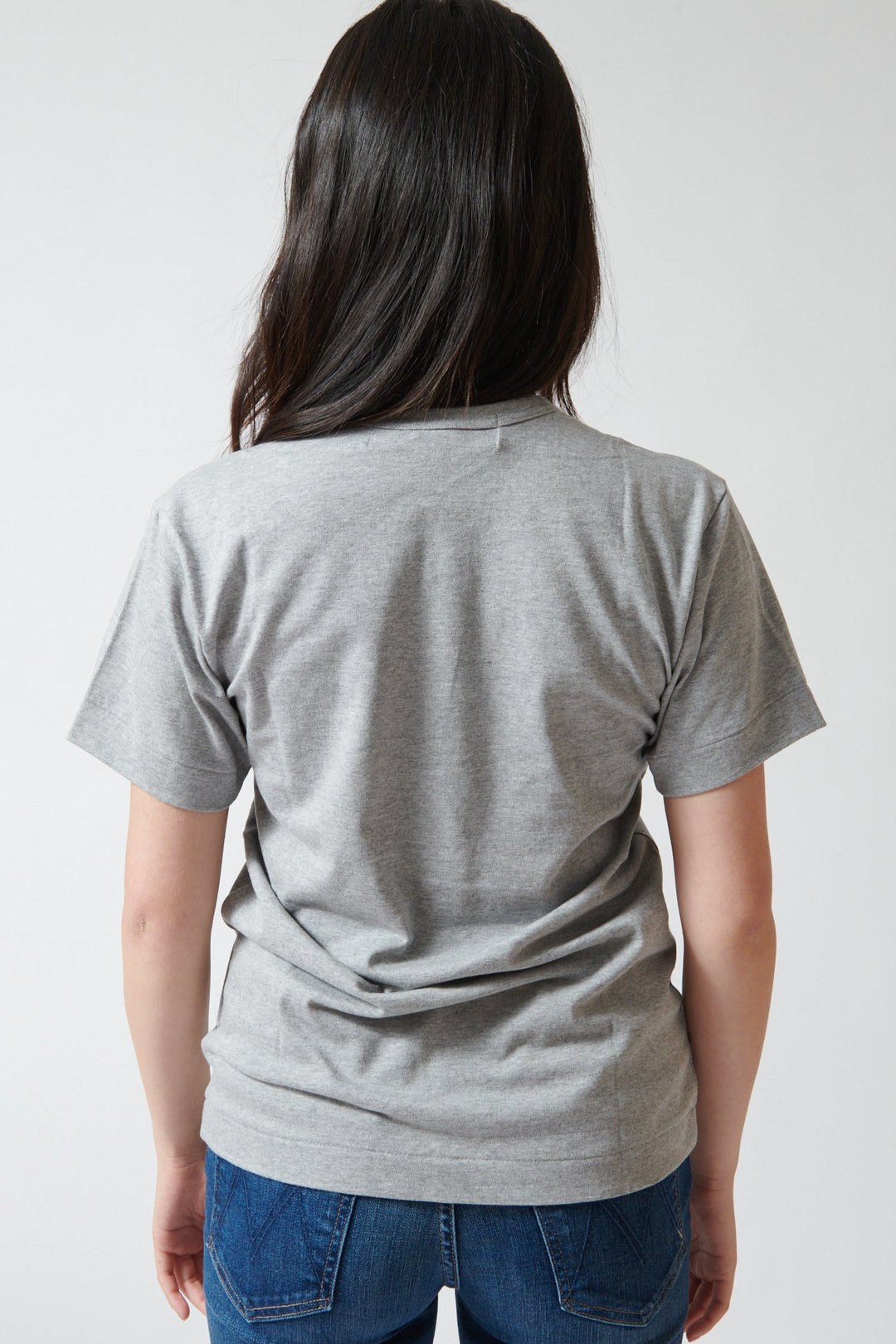 Lilly wearing Comme des Garçons PLAY Trio Heart Logo Print T-Shirt rear view