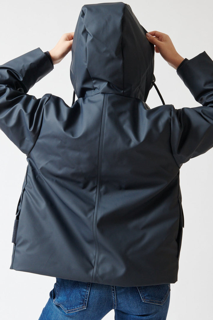 Lilly wearing Rains Nome Short W Parka rear view