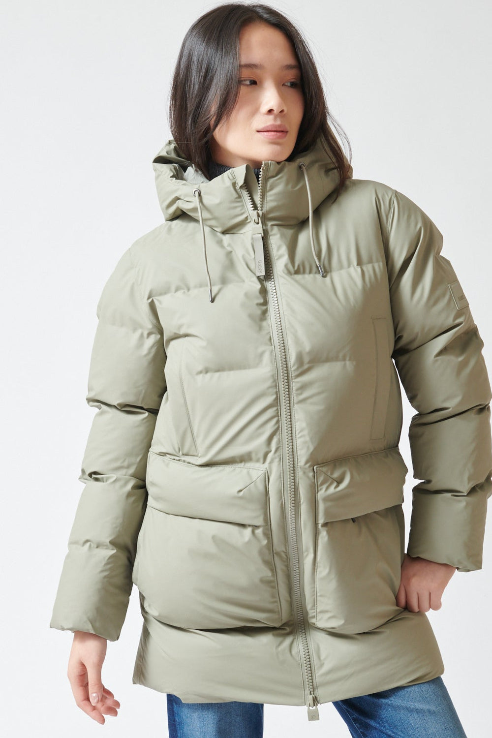 Lilly wearing Rains Alta Long Puffer Cargo Jacket front view