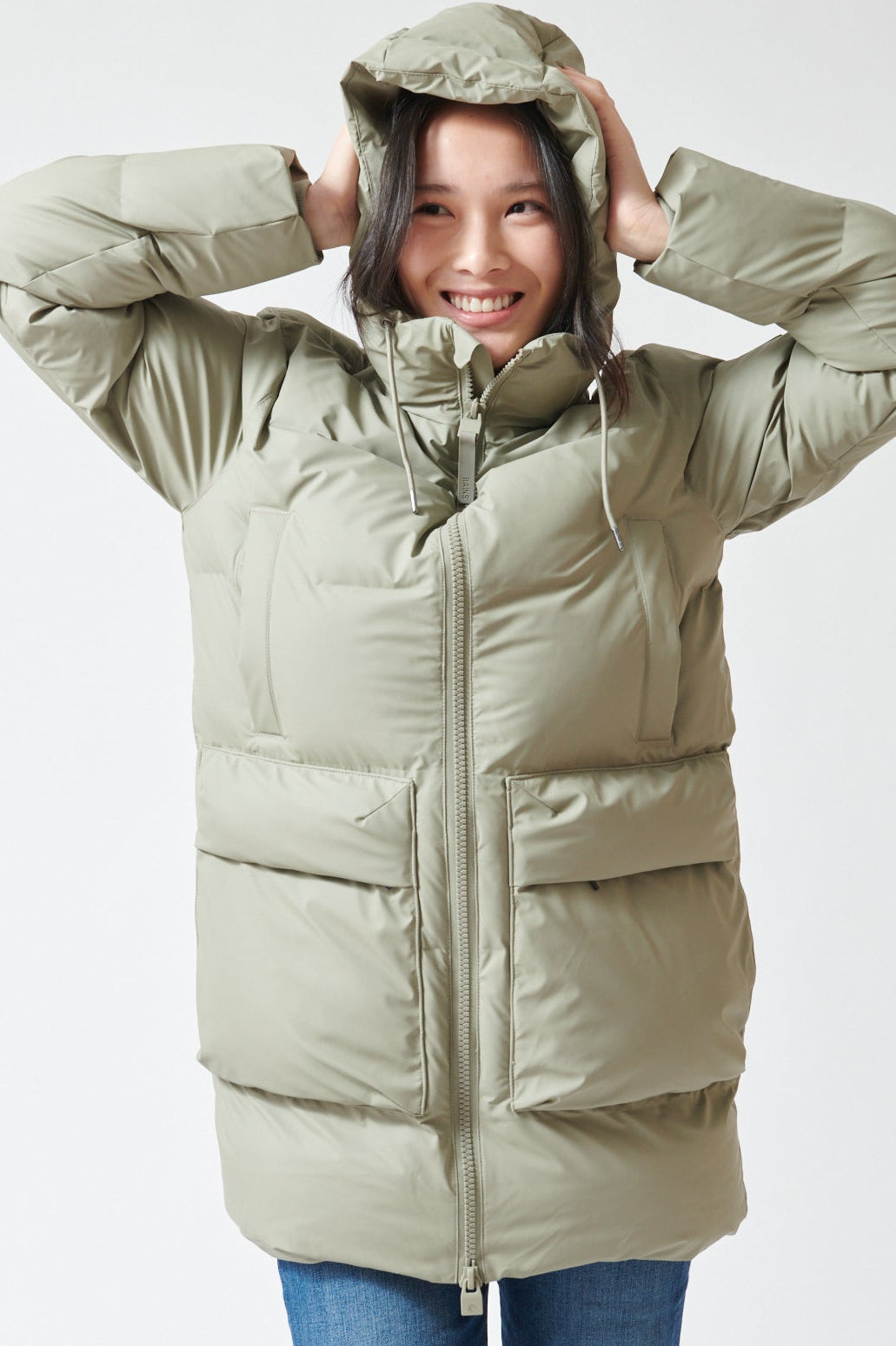 Lilly wearing Rains Alta Long Puffer Cargo Jacket front view